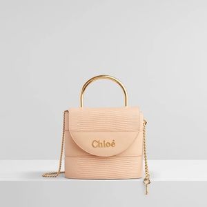 Small Aby Lizard-Embossed Leather Top Handle Bag
Light Pink